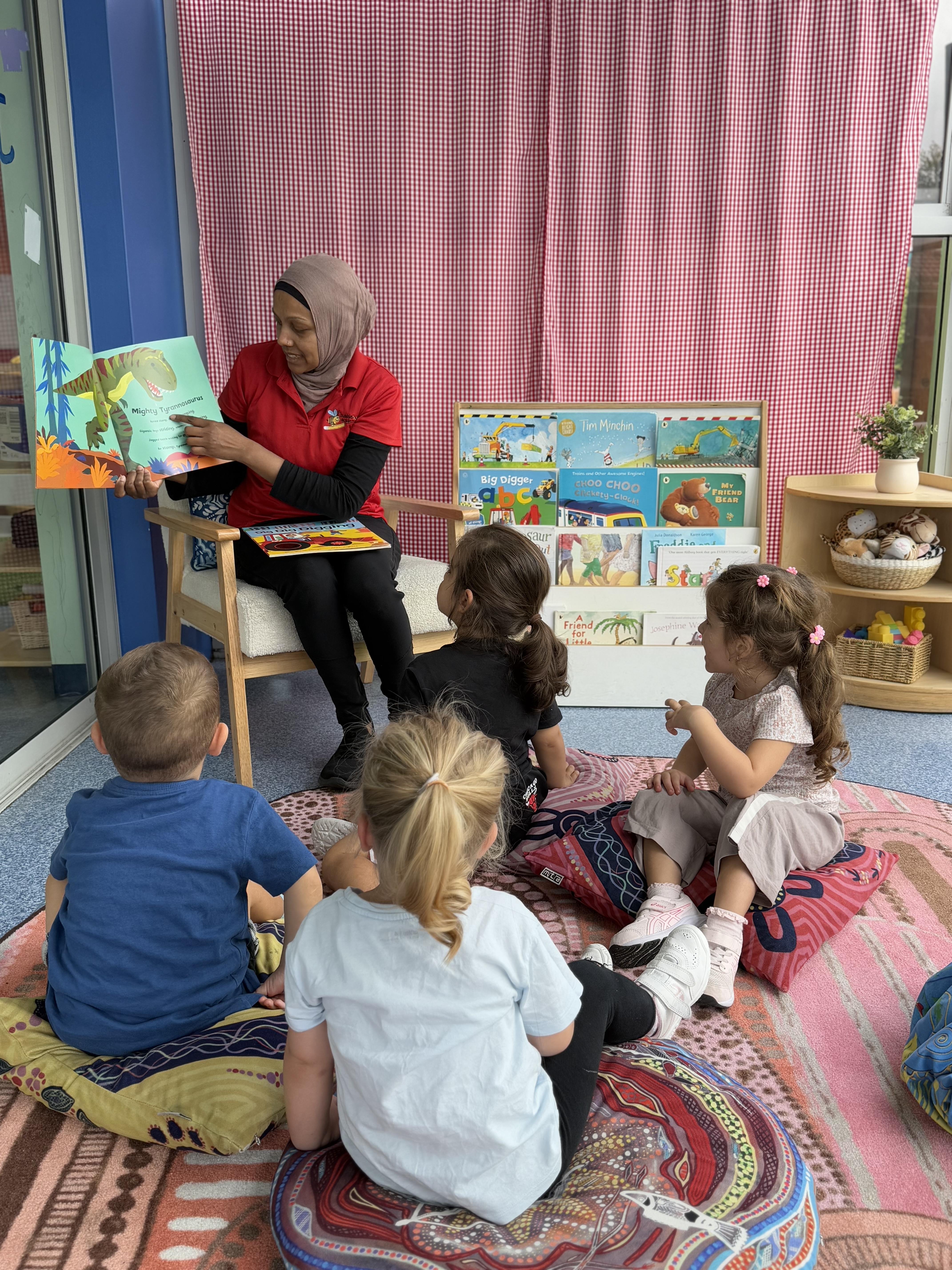 Educator reading a book to a group of students
